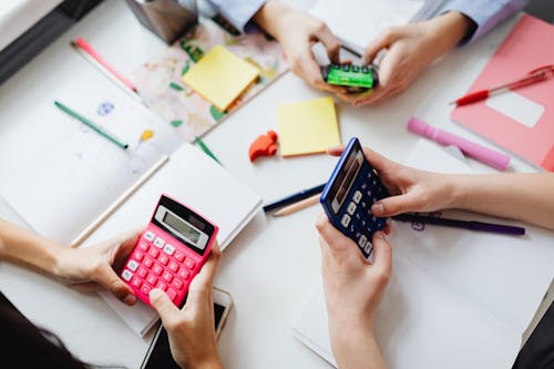 Free Three People Using Calculators Stock Photo